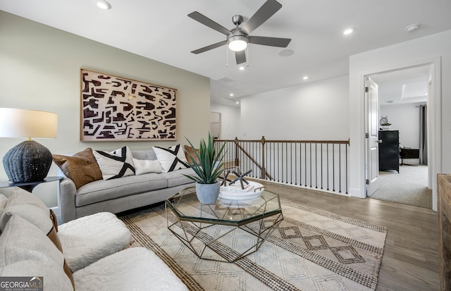 living area featuring ceiling fan, baseboards, wood finished floors, and recessed lighting