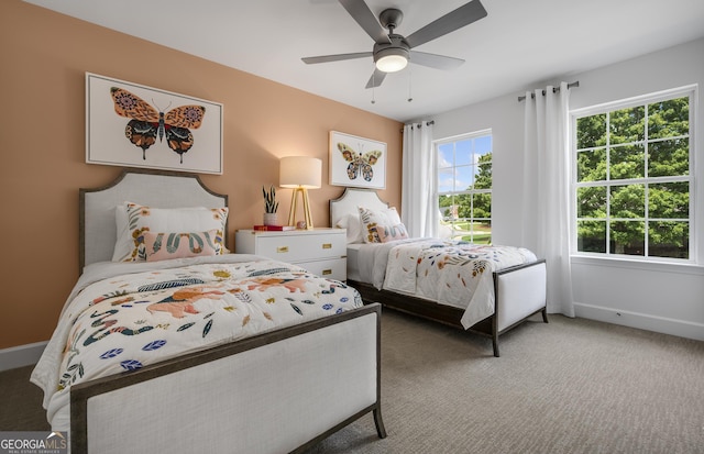 bedroom featuring ceiling fan, carpet, and baseboards