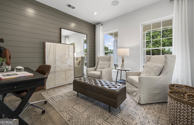 office with wood walls, wood finished floors, visible vents, and recessed lighting