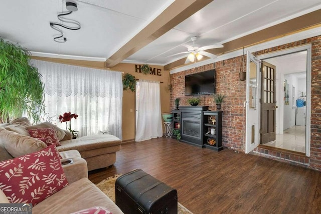 living area with a ceiling fan, beamed ceiling, and wood finished floors