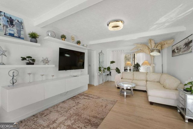 living area featuring a textured ceiling, beamed ceiling, and wood finished floors