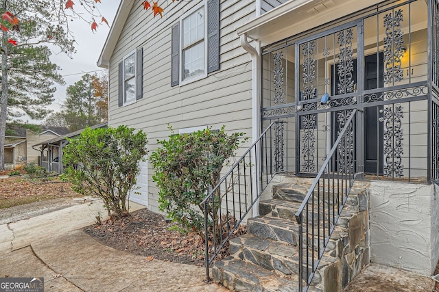 doorway to property with a garage and driveway