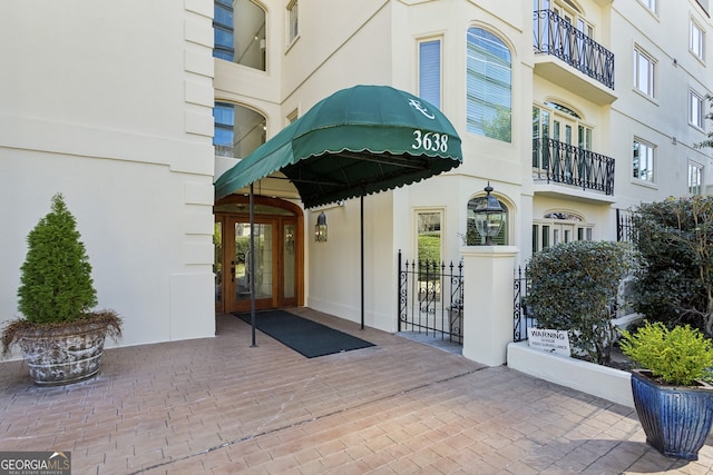 property entrance with french doors and stucco siding