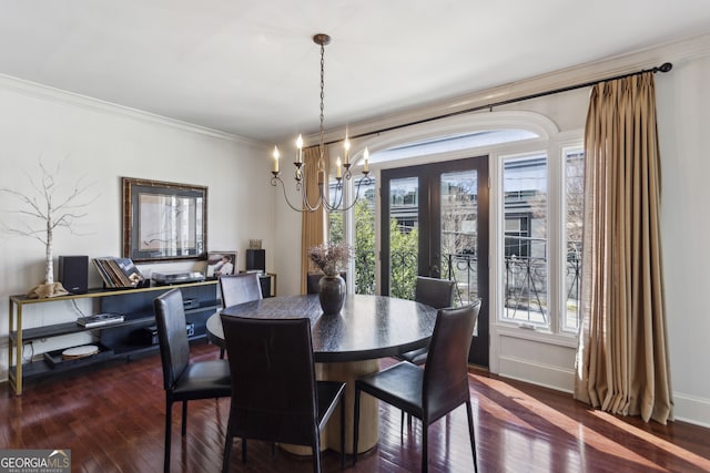 dining room with plenty of natural light, ornamental molding, a chandelier, and hardwood / wood-style floors