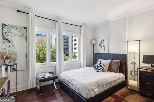 bedroom with crown molding, dark wood finished floors, and baseboards