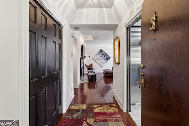 entryway featuring wood finished floors and baseboards