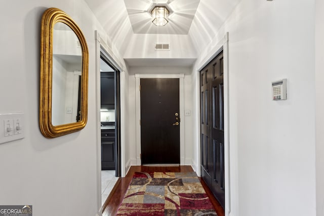 doorway featuring wood finished floors and visible vents