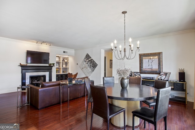 dining room featuring crown molding, a fireplace, visible vents, and dark wood-type flooring