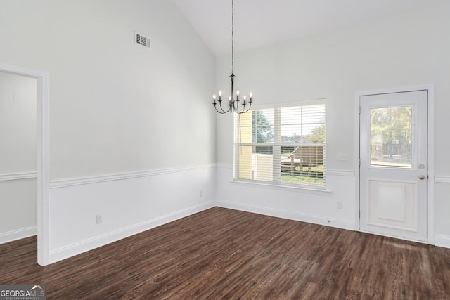 unfurnished dining area with baseboards, dark wood-style flooring, and a notable chandelier