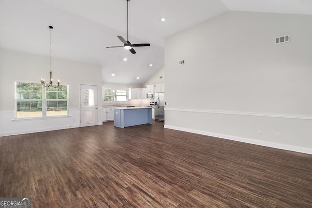 unfurnished living room with baseboards, visible vents, dark wood-type flooring, and ceiling fan with notable chandelier