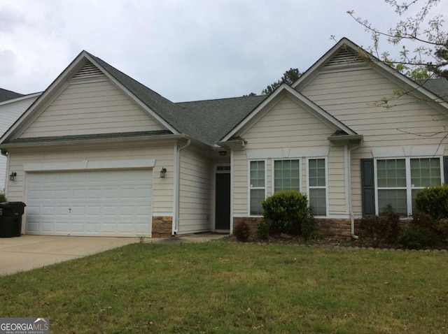 view of front of home with a garage, driveway, a front lawn, and stone siding