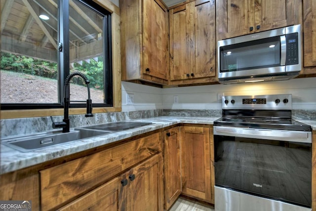 2634 Mountain View Rd, Mccaysville, GA 30555 - kitchen featuring appliances with stainless steel finishes and brown cabinets
