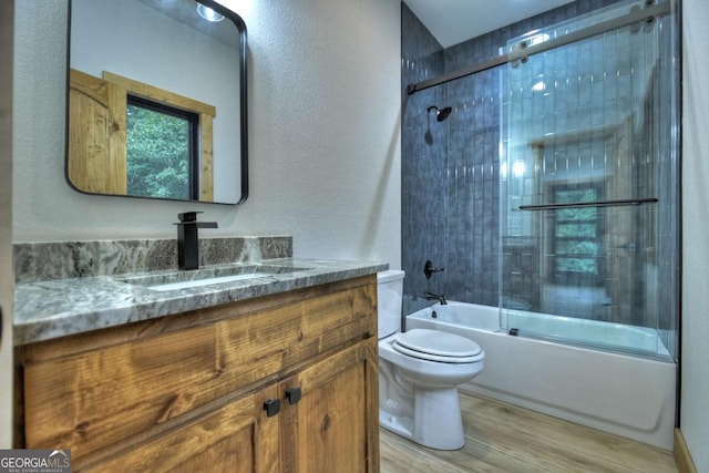 2634 Mountain View Rd, Mccaysville, GA 30555 - bathroom featuring vanity, wood finished floors, enclosed tub / shower combo, and a textured wall