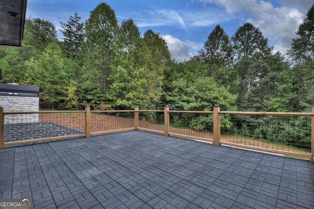 wooden terrace with a patio area