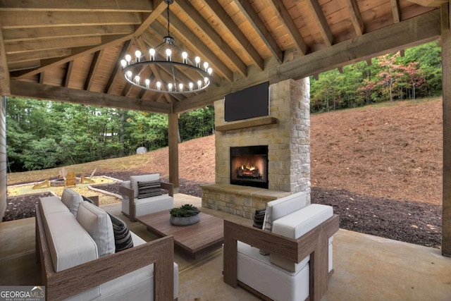 view of patio with an outdoor living space with a fireplace and a gazebo