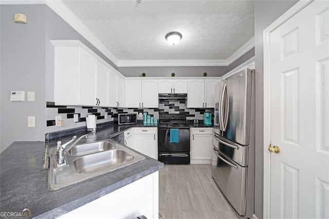 kitchen featuring appliances with stainless steel finishes, dark countertops, a sink, and white cabinets