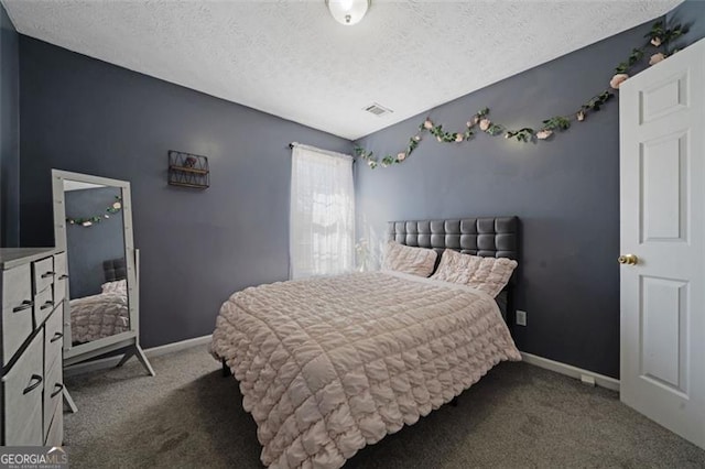 carpeted bedroom with a textured ceiling, visible vents, and baseboards