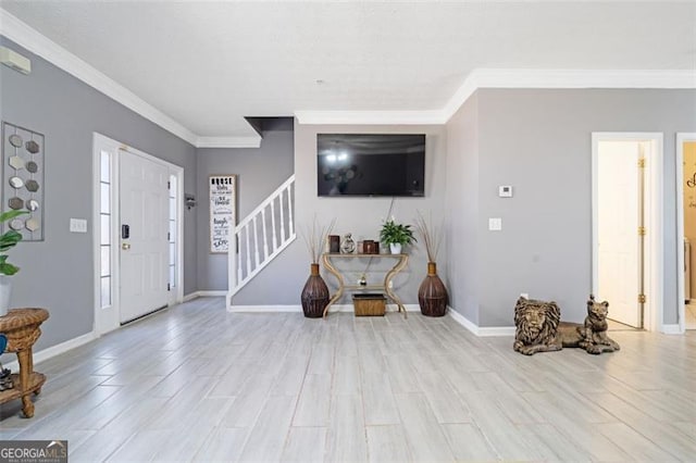 entryway featuring baseboards, stairway, wood finished floors, and crown molding