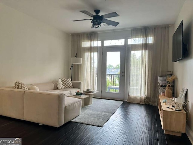 living room with ceiling fan and dark wood-style flooring