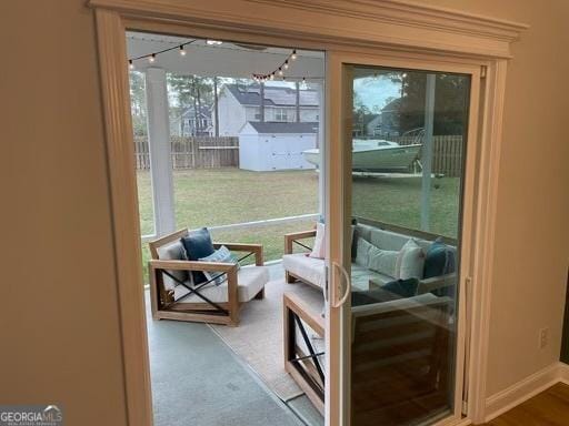 doorway to outside featuring baseboards