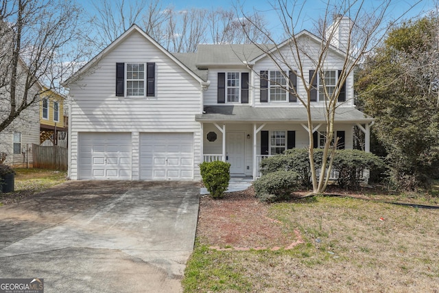 traditional home with driveway, covered porch, an attached garage, and fence