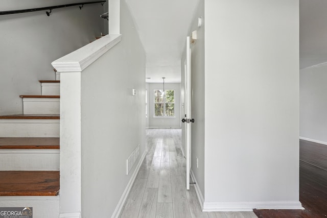 interior space featuring visible vents, baseboards, and wood finished floors