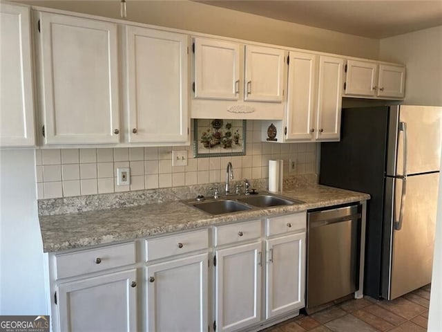 kitchen with stainless steel appliances, white cabinets, and a sink