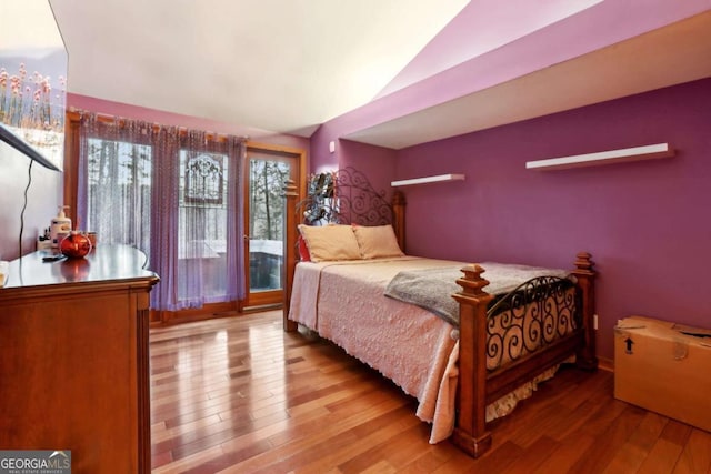 bedroom featuring vaulted ceiling and wood finished floors