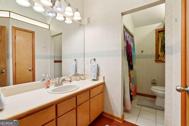 bathroom with toilet, tile patterned flooring, and vanity