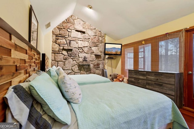 bedroom with lofted ceiling and visible vents