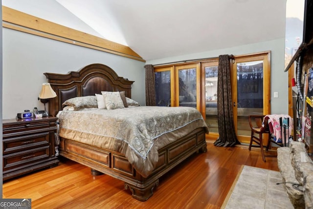 bedroom featuring vaulted ceiling and wood finished floors