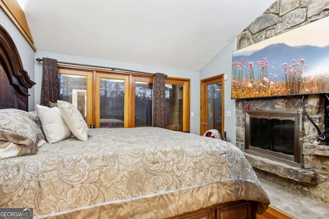 bedroom featuring lofted ceiling and a fireplace