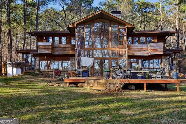 rear view of property featuring a yard