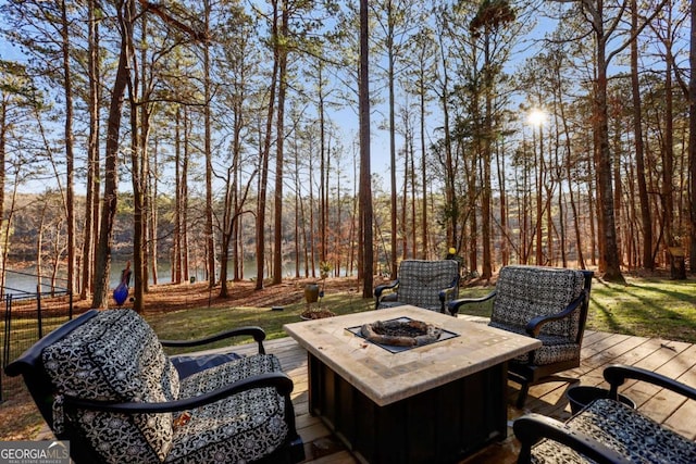 view of patio / terrace featuring an outdoor fire pit and a deck