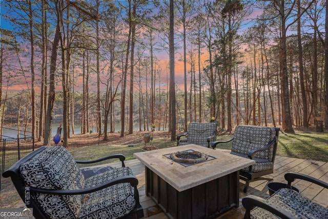 patio terrace at dusk featuring an outdoor fire pit