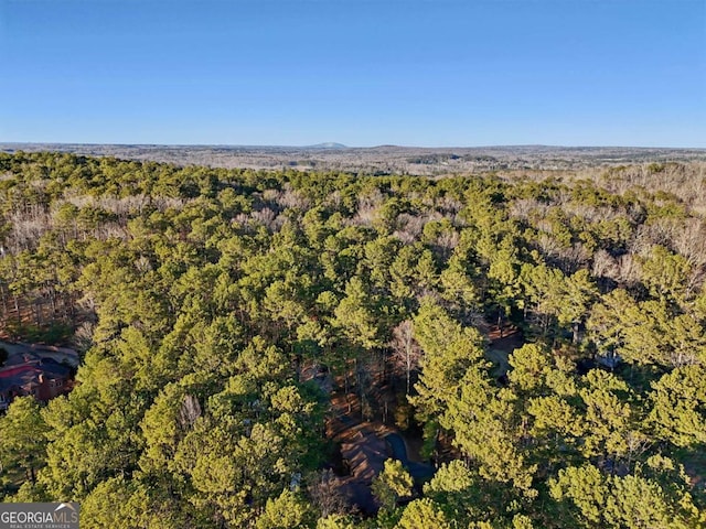 birds eye view of property with a wooded view