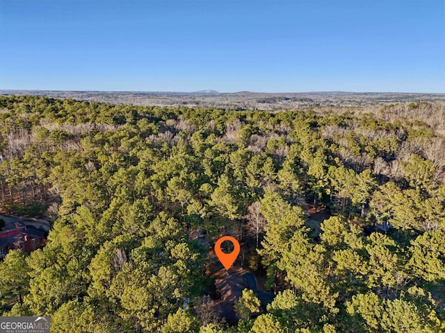 bird's eye view featuring a wooded view