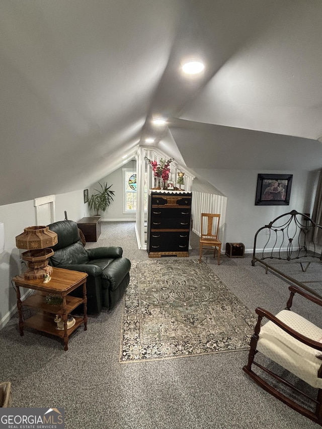 carpeted living room featuring lofted ceiling and baseboards