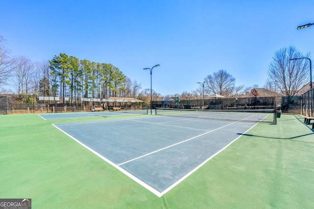 view of sport court featuring fence