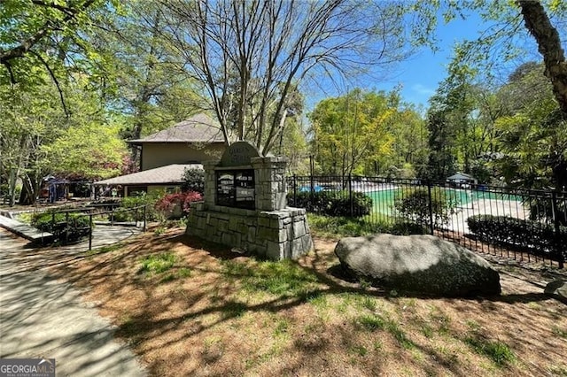 view of yard featuring a swimming pool and fence