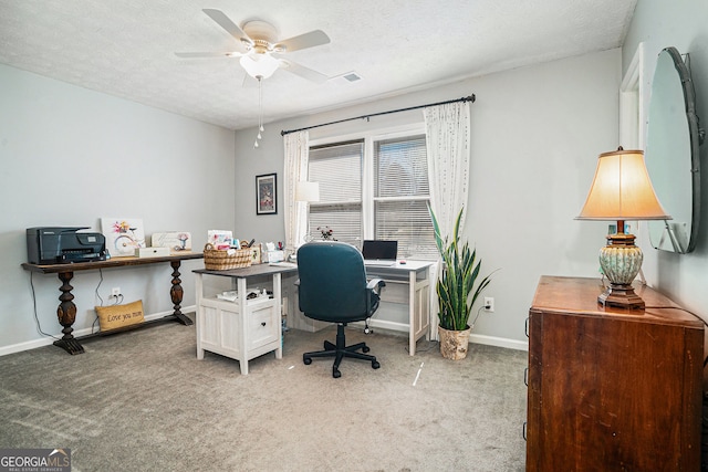 office area featuring a ceiling fan, light colored carpet, visible vents, and a textured ceiling