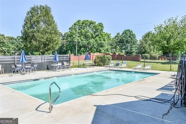 pool featuring fence and a patio