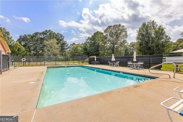 pool featuring a patio area and fence