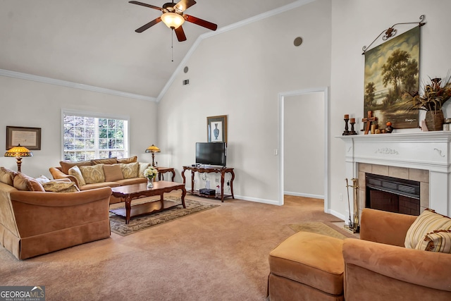 living area with high vaulted ceiling, carpet flooring, baseboards, a tiled fireplace, and crown molding