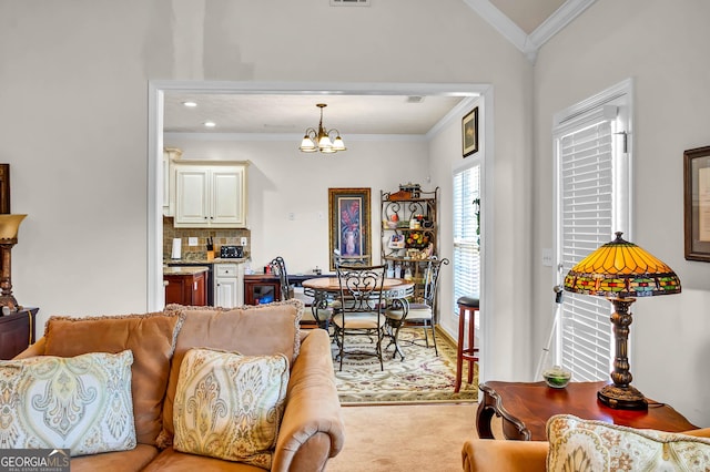 living area with light carpet, ornamental molding, a chandelier, and visible vents