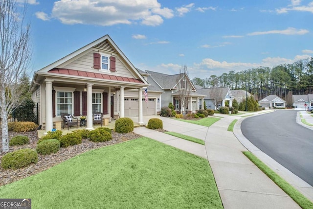 view of front of property with concrete driveway, metal roof, covered porch, a standing seam roof, and a front lawn