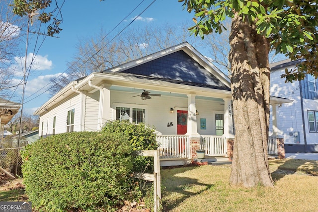 bungalow with a ceiling fan, a front yard, and covered porch