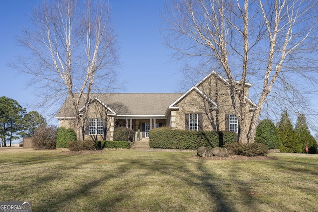 view of front of house with stone siding and a front yard