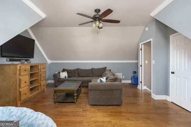 living area featuring a ceiling fan, baseboards, and wood finished floors