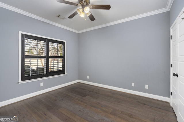 empty room featuring ornamental molding, dark wood-type flooring, visible vents, and baseboards